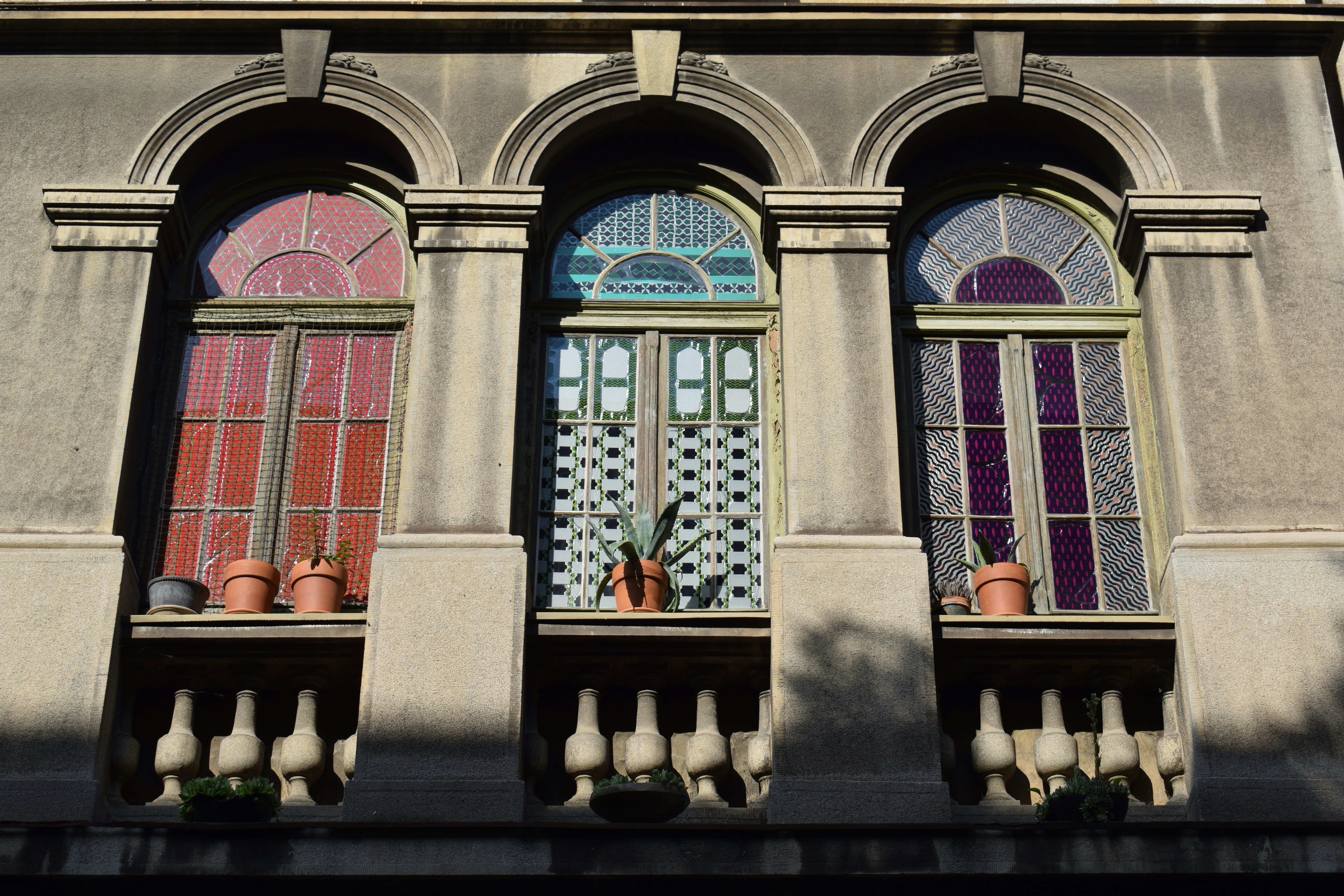 A building with three windows and a clock on the top of it photo – Free ...
