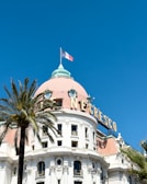 a large white building with a flag on top of it
