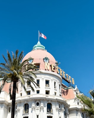 a large white building with a flag on top of it