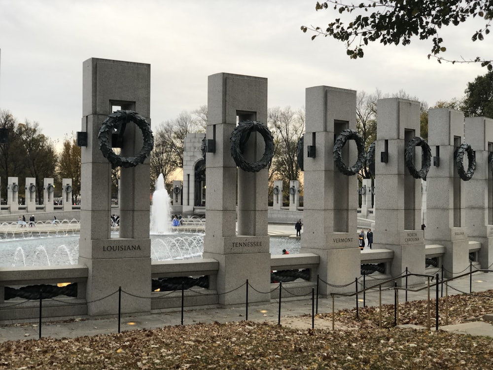 a group of cement pillars with wreaths on them