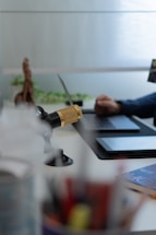 A friendly desk setup with a microphone, headphones, and music notes floating around, symbolizing communication for a music awards event.