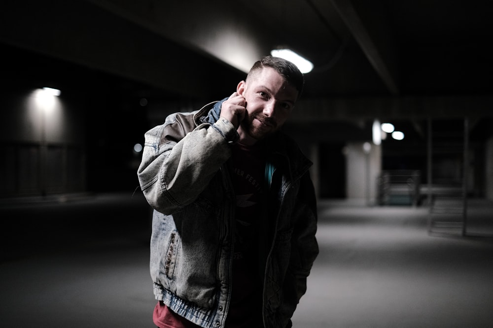 a man in a parking garage talking on a cell phone