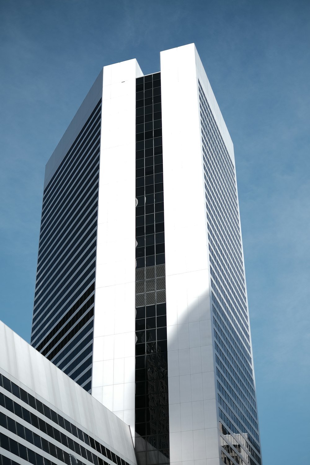 a tall white building with a sky background