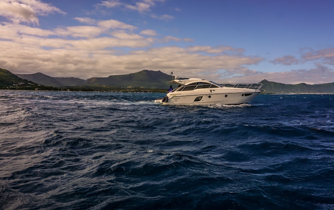 a white boat in the middle of a body of water,