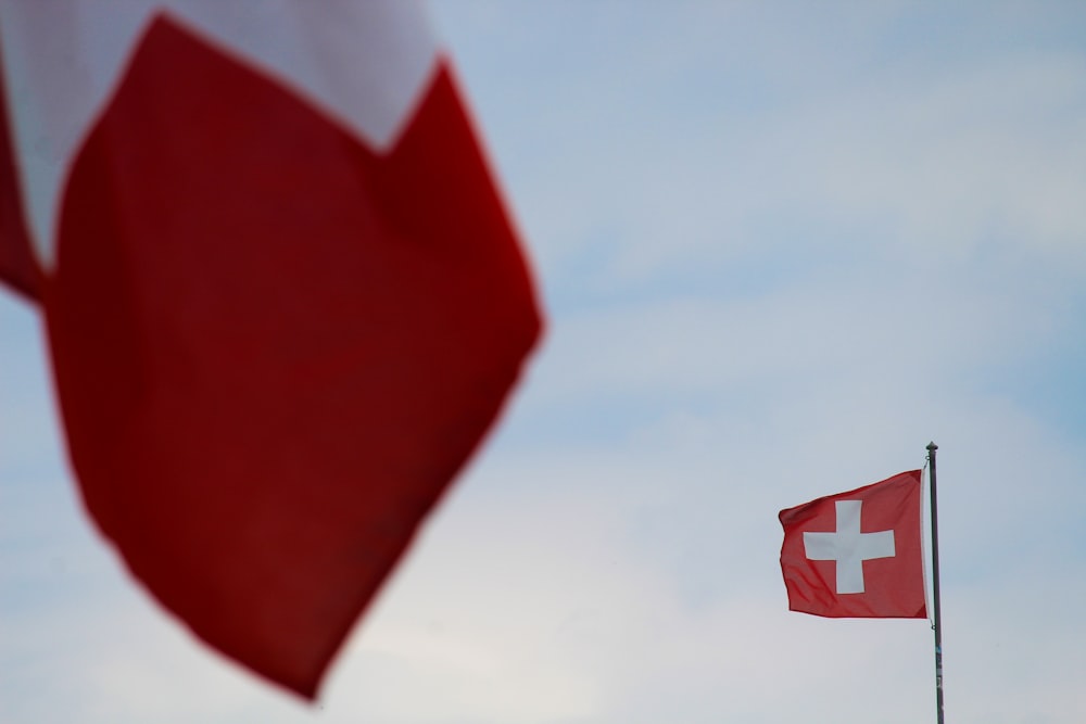a swiss flag flying next to a swiss flag
