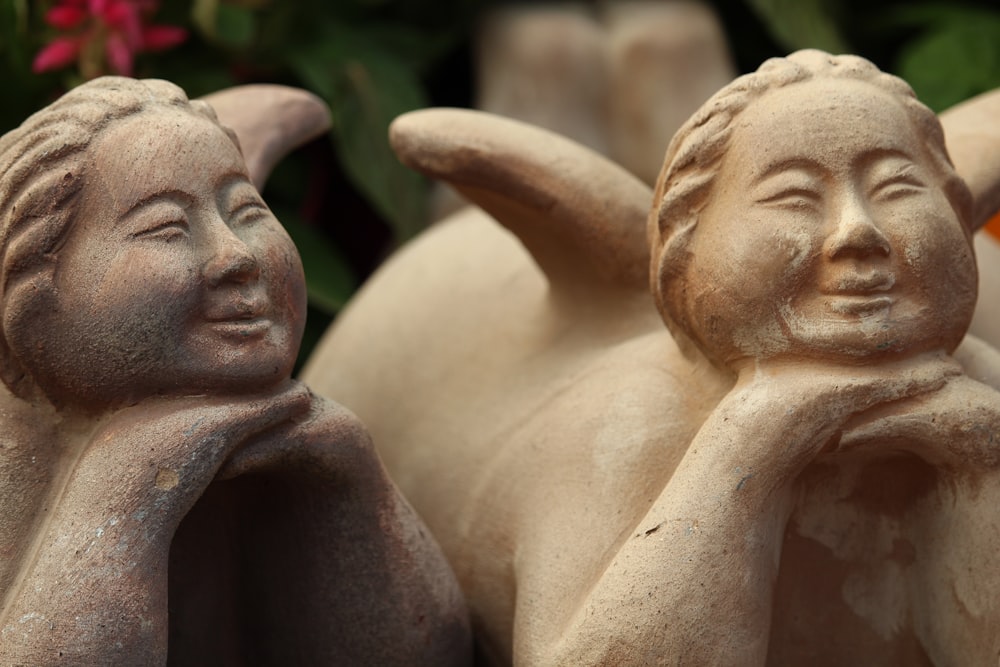 a close up of two statues of women