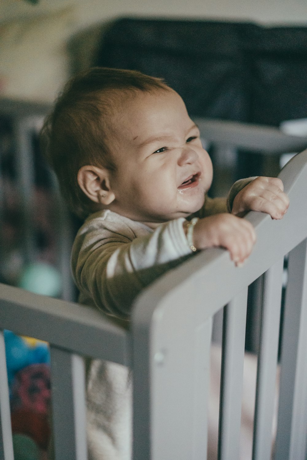 a baby is laughing in a crib