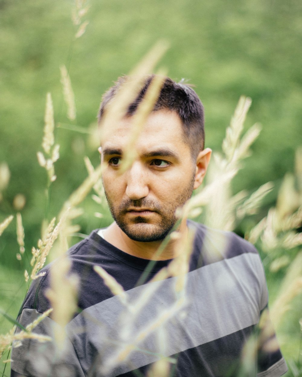 a man standing in a field of tall grass