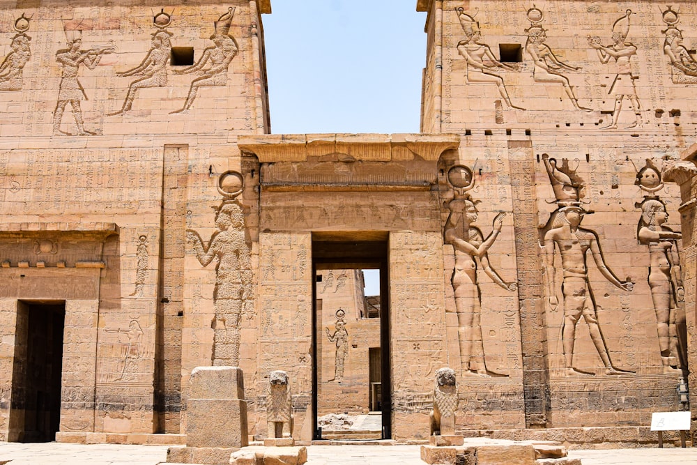 the entrance to a large building with carvings on it