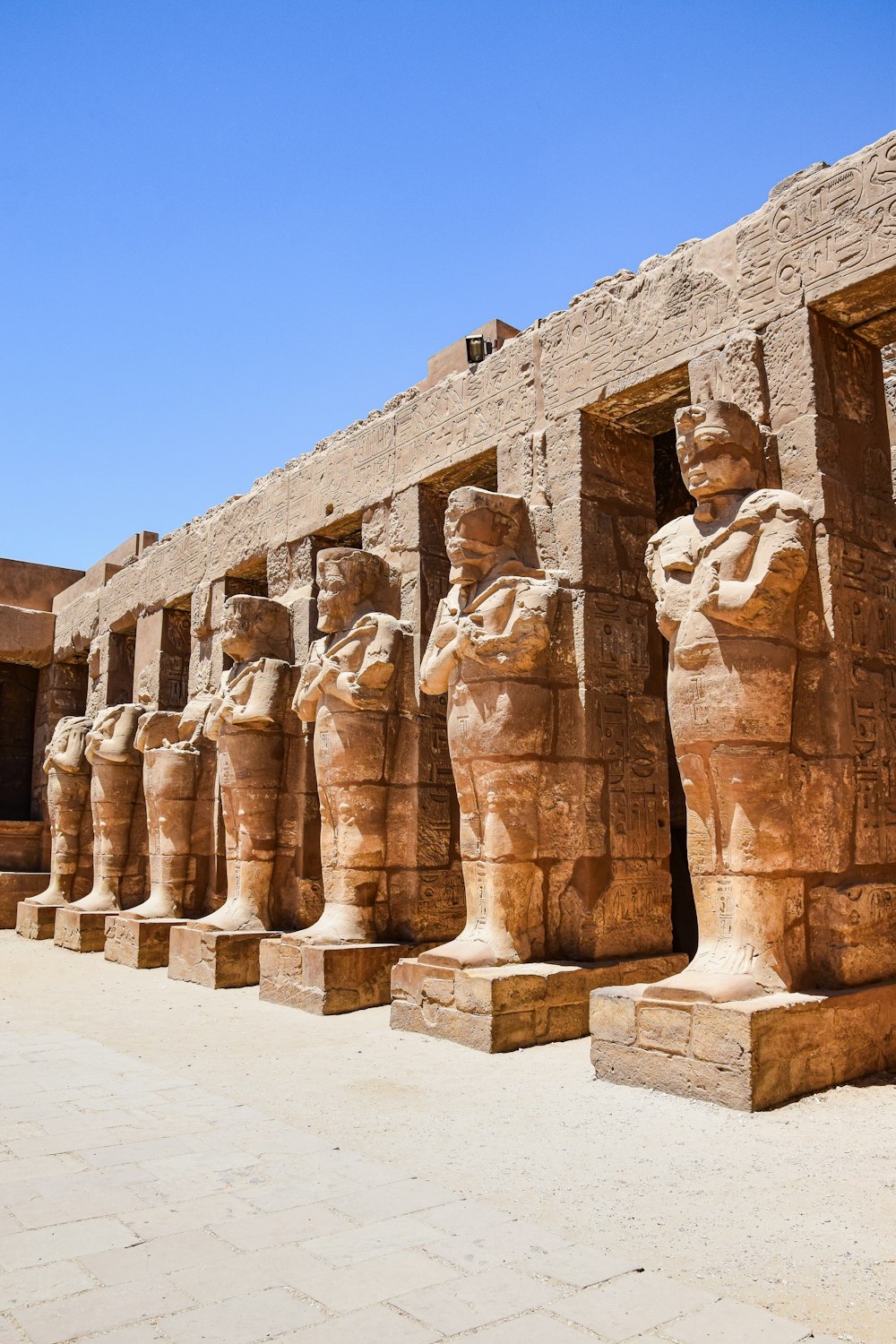 a row of statues in front of a building