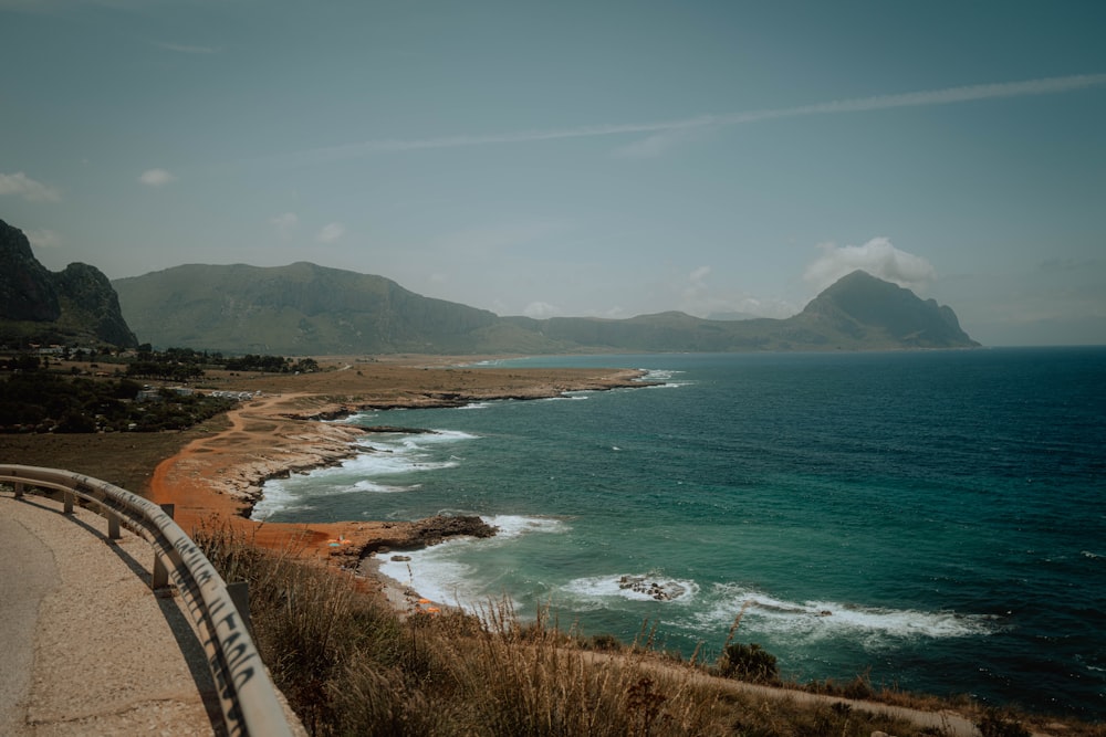 a scenic view of the ocean and mountains