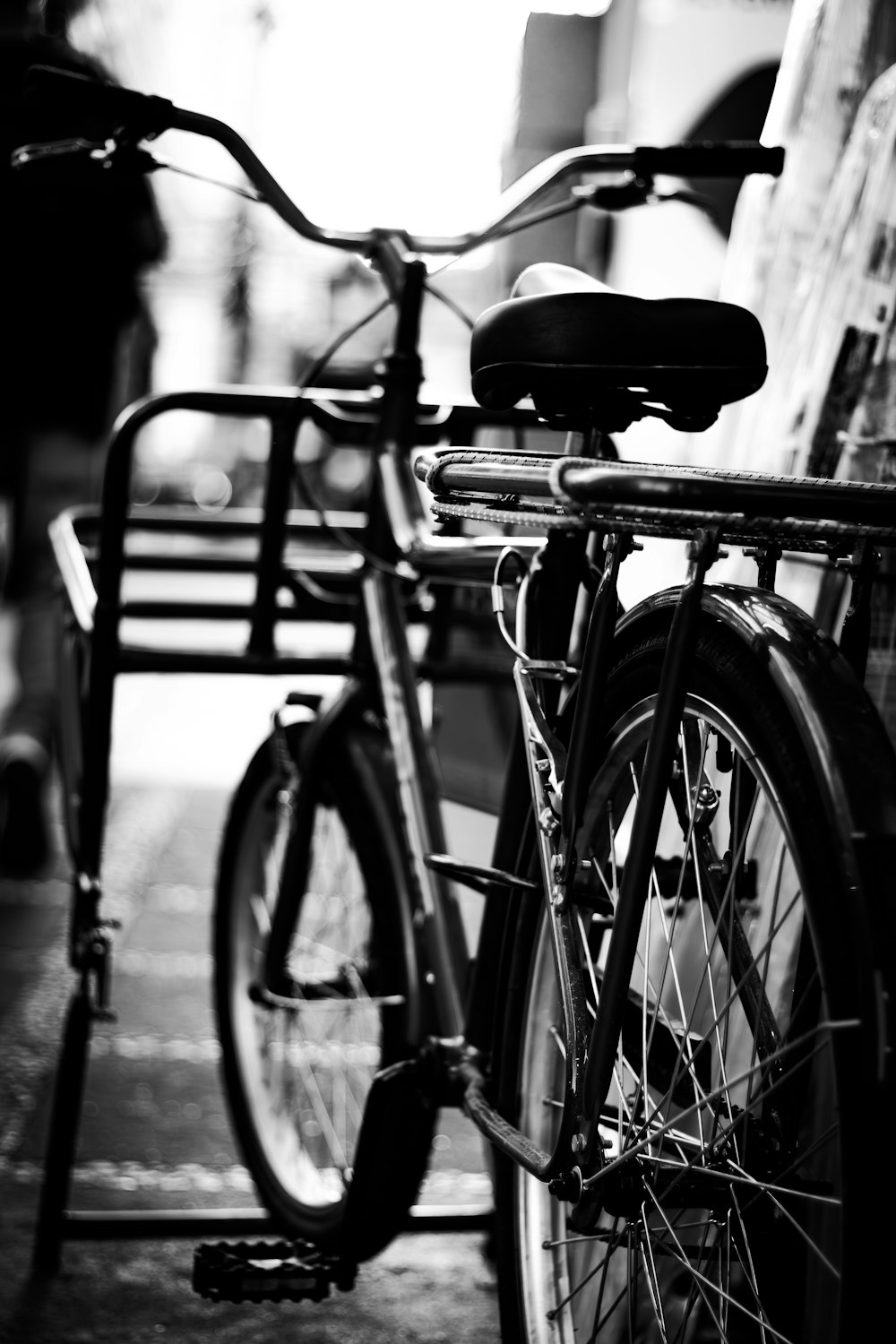 a bicycle parked next to a bench on a sidewalk