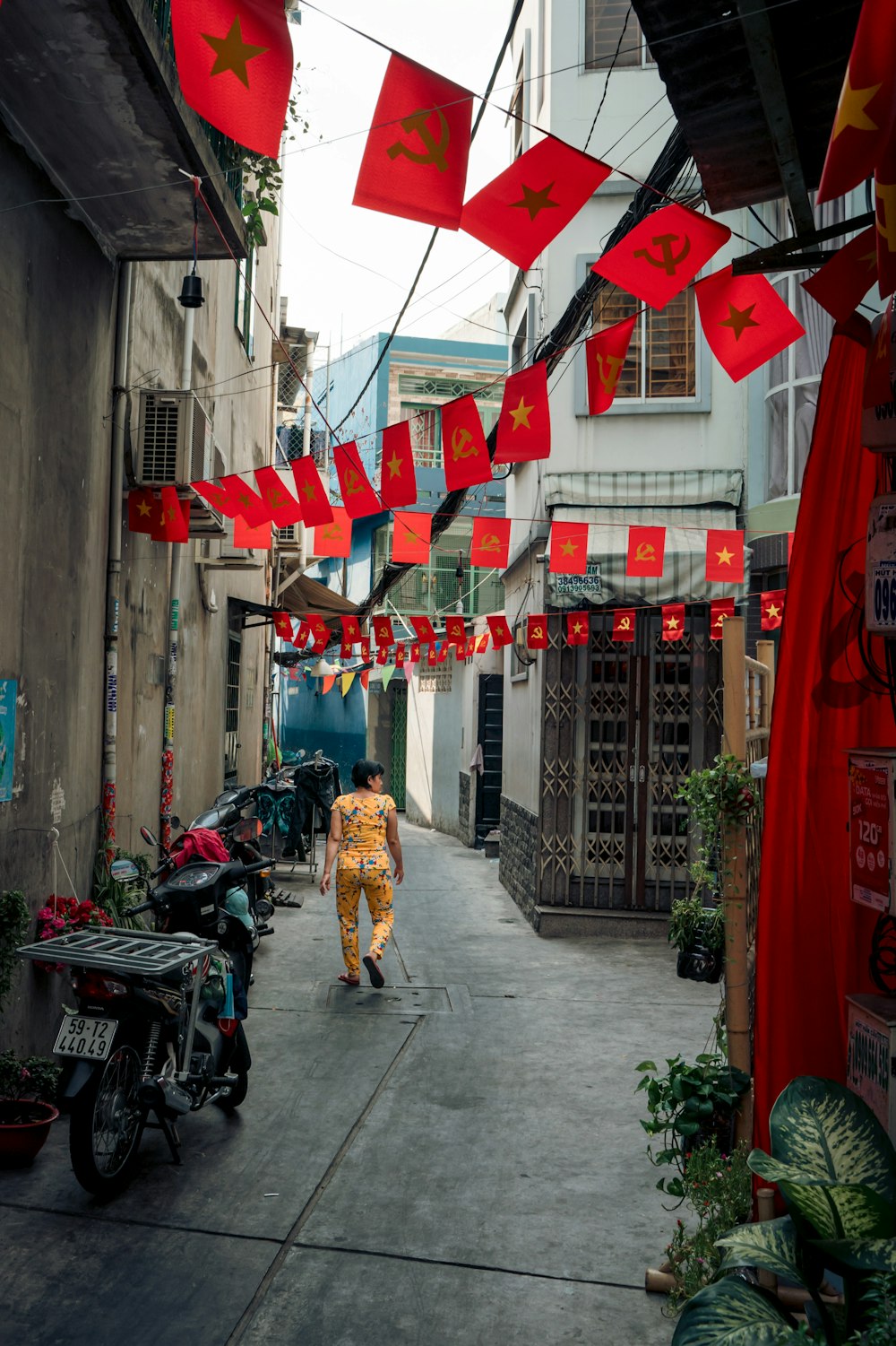 a person walking down a street with red flags