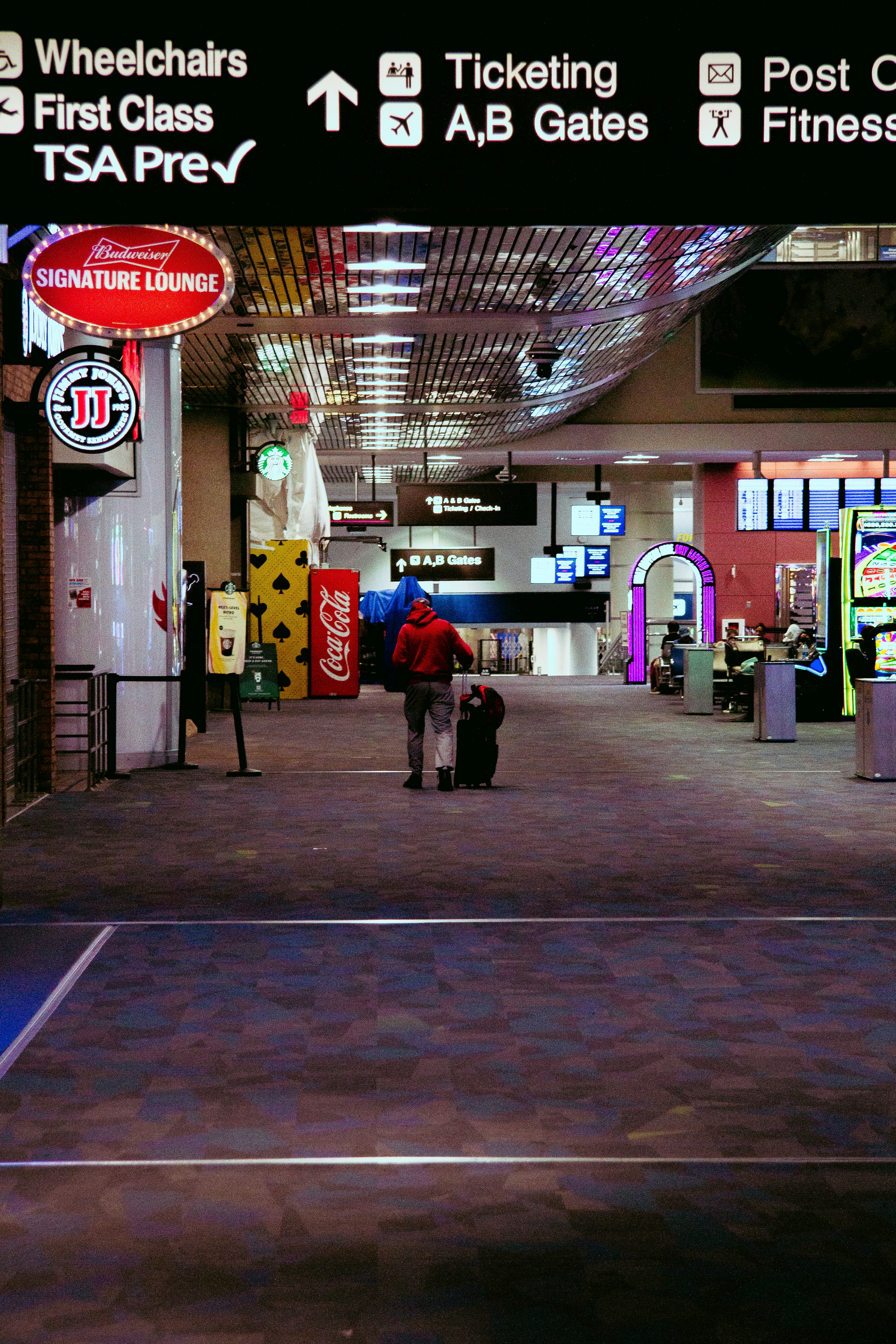 a tennis court with a person holding a suitcase