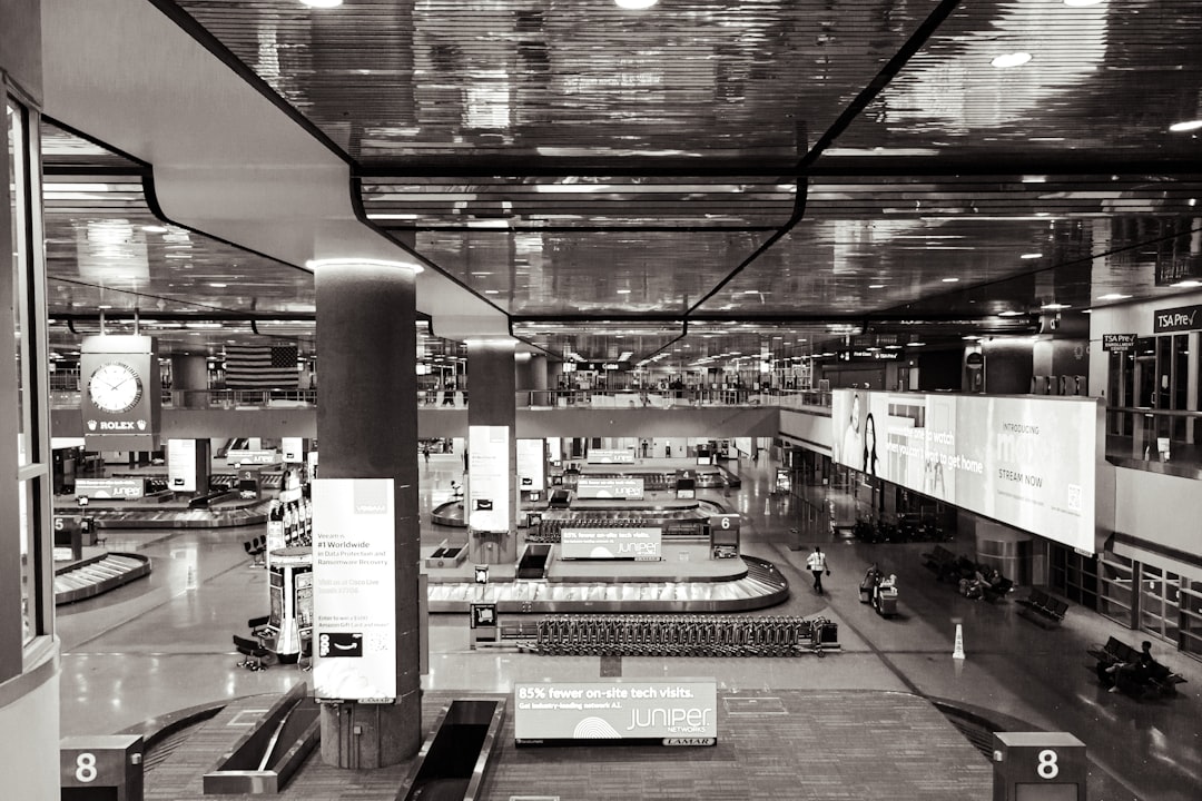 a black and white photo of a train station,
