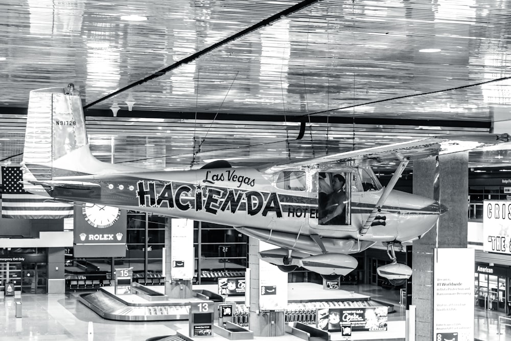 a black and white photo of a plane inside of a building