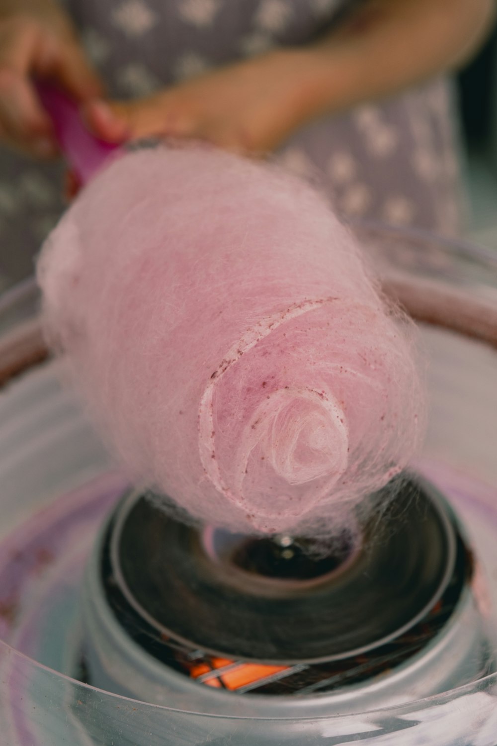 a pink ball of yarn is in a bowl