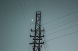 a telephone pole with a full moon in the sky