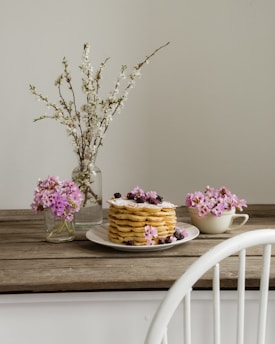 a table with a cake and flowers on it