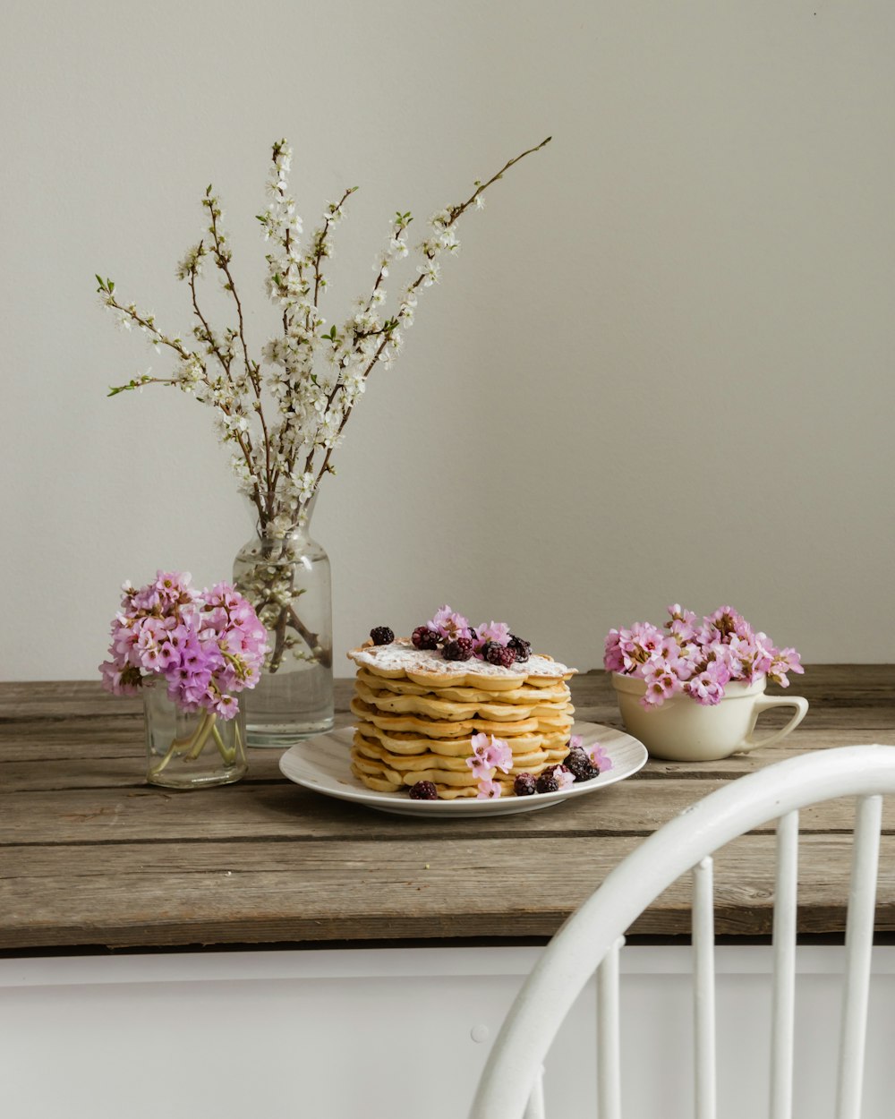 a table with a cake and flowers on it