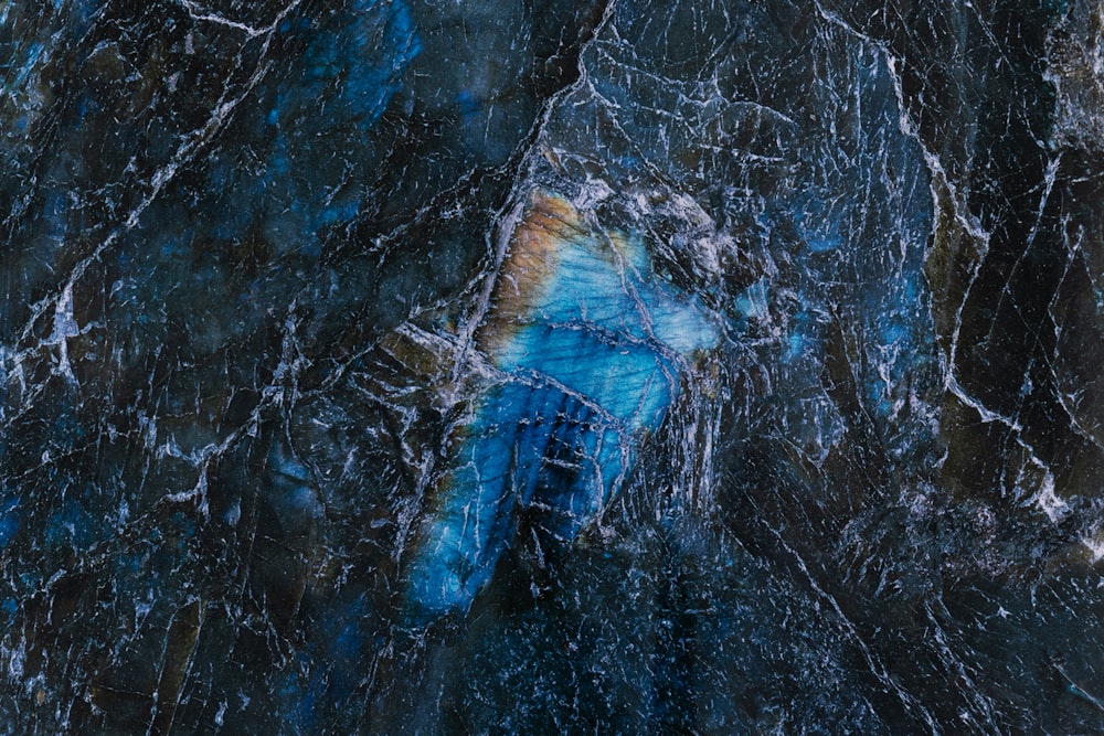 a close up of a blue and black marble