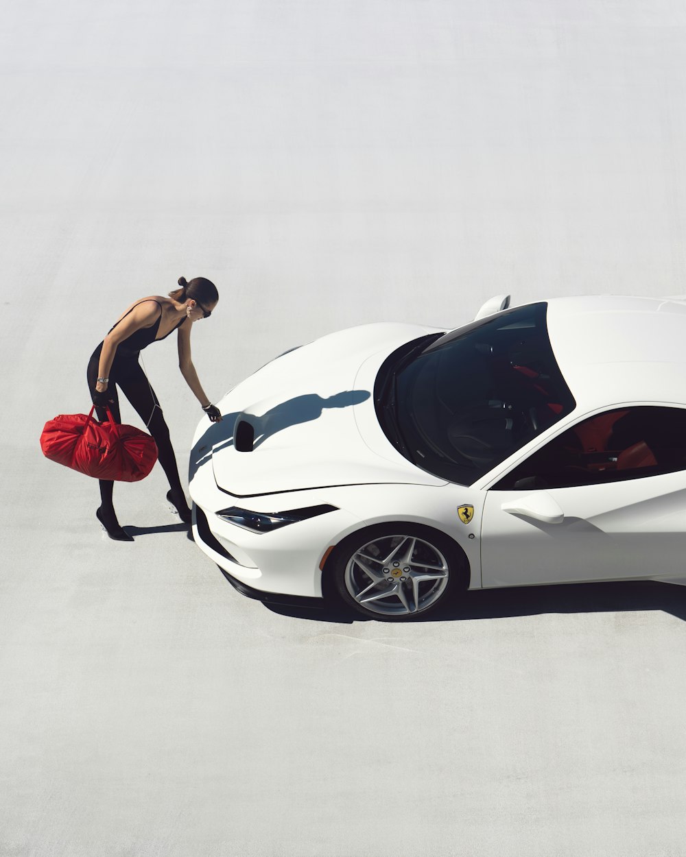 a man standing next to a white sports car