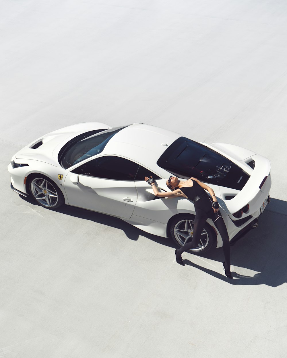 a man standing next to a white sports car