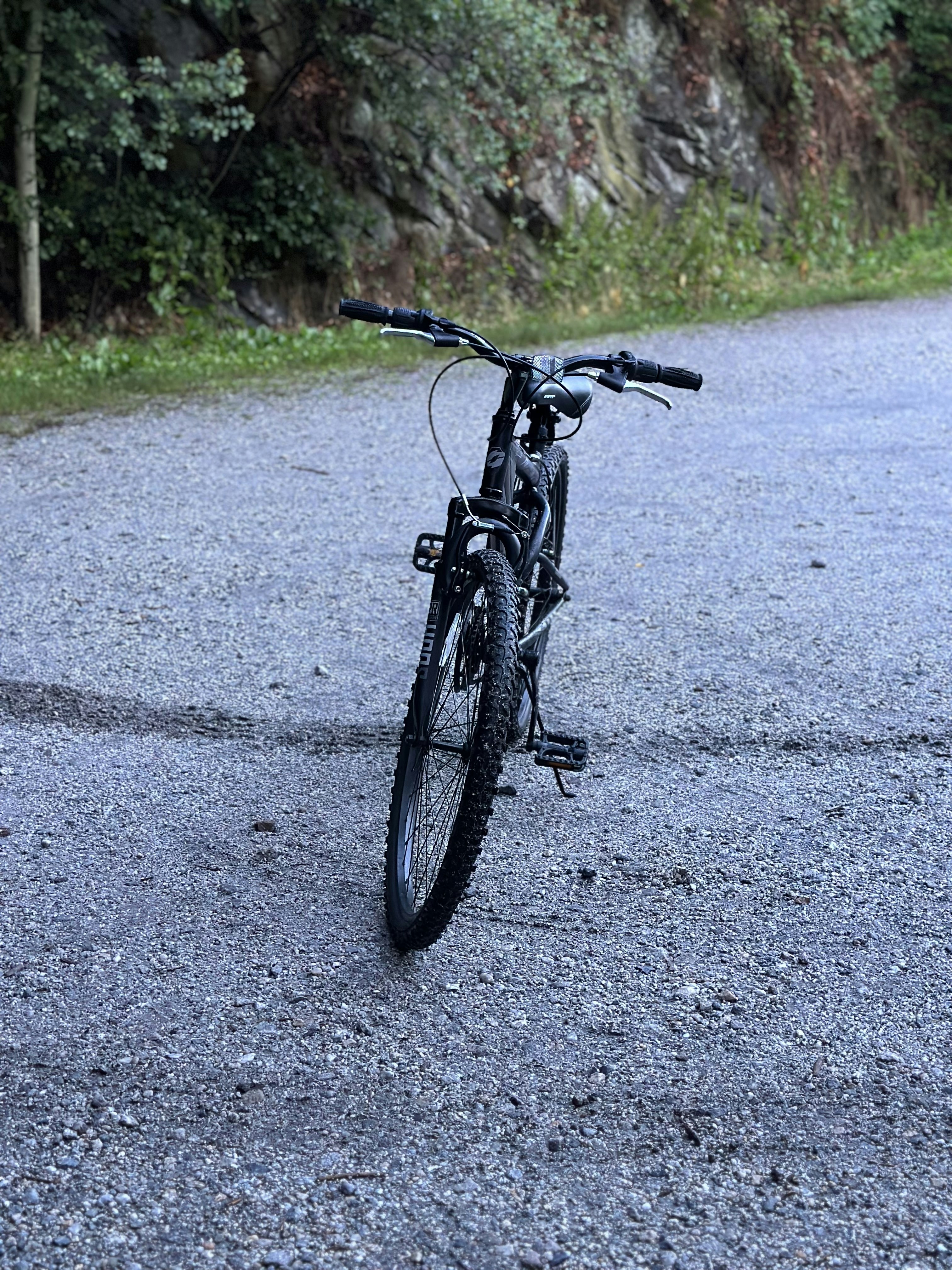 a bicycle parked on the side of a road