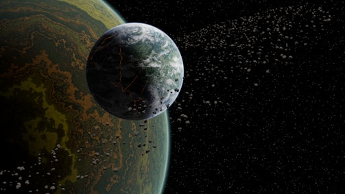 A large planet with a textured surface is positioned near the edge of the frame, with an abundance of smaller celestial bodies orbiting around it against a backdrop of space. The planet displays shades of green, brown, and yellow, creating a complex pattern. The surrounding space is dark, dotted with numerous scattered asteroids or moons.