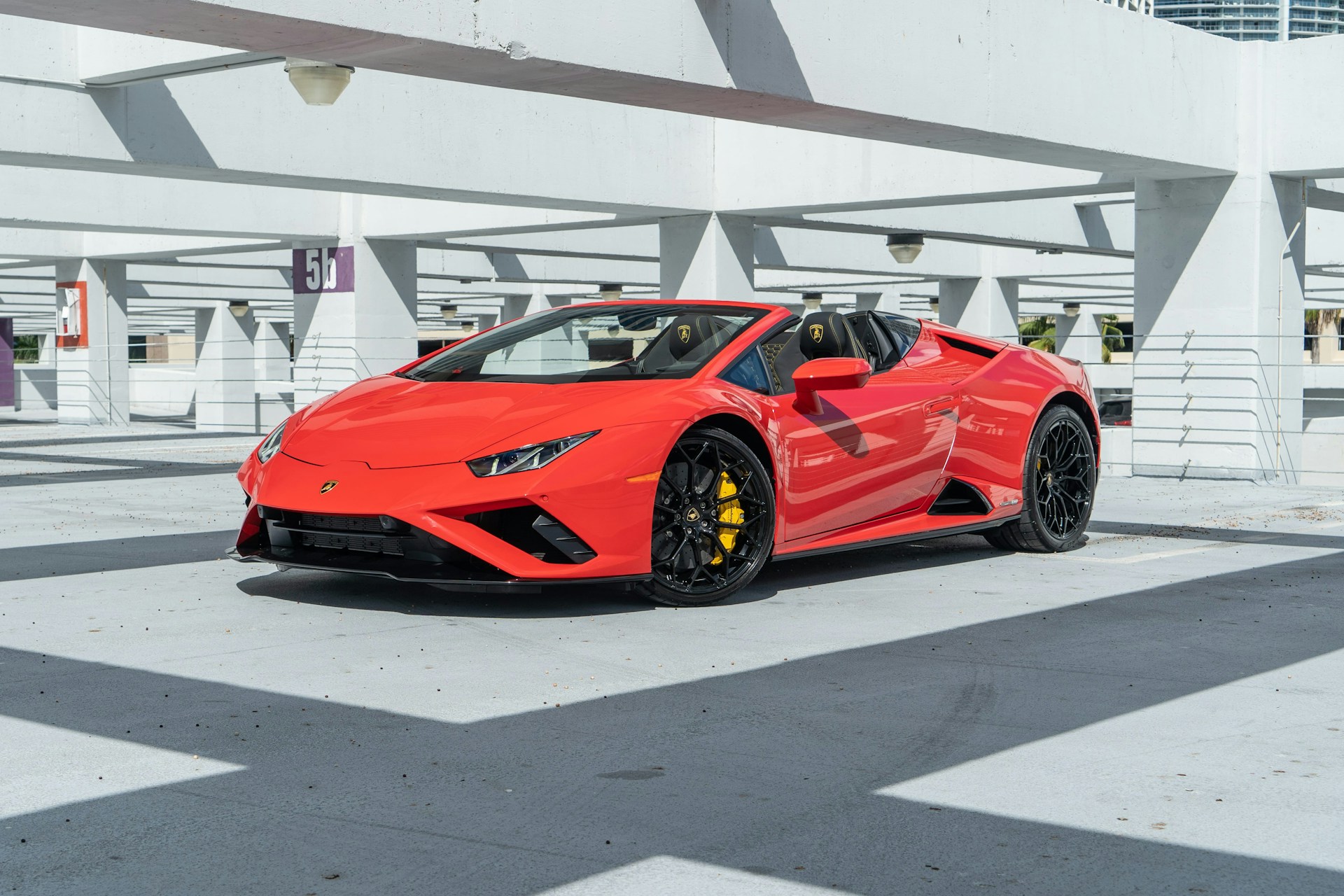 a red sports car parked in a parking lot