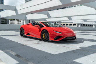 a red sports car parked in a parking lot