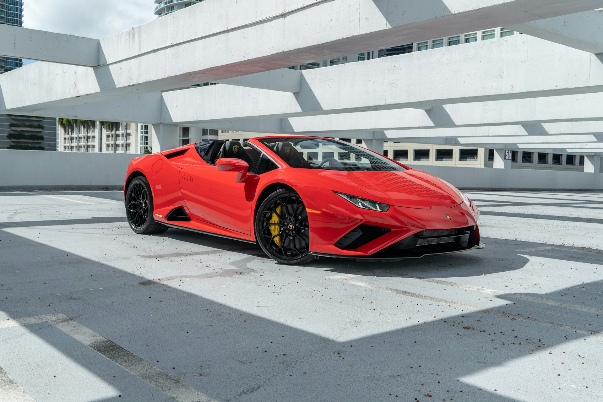 a red sports car parked in a parking lot