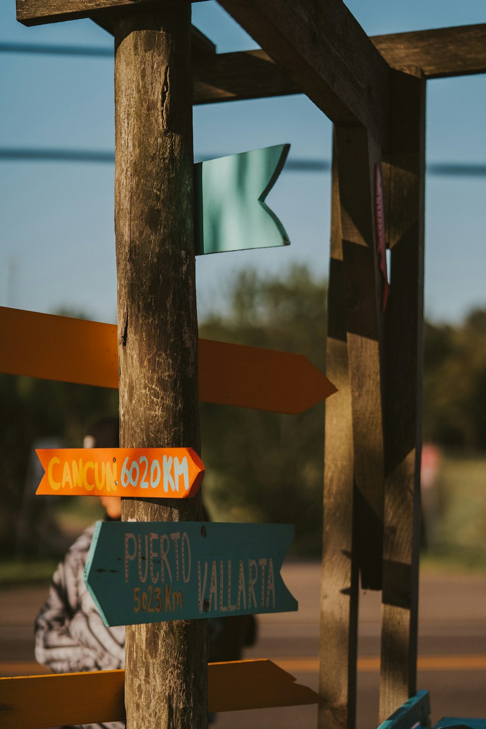 a wooden pole with a bunch of signs on it