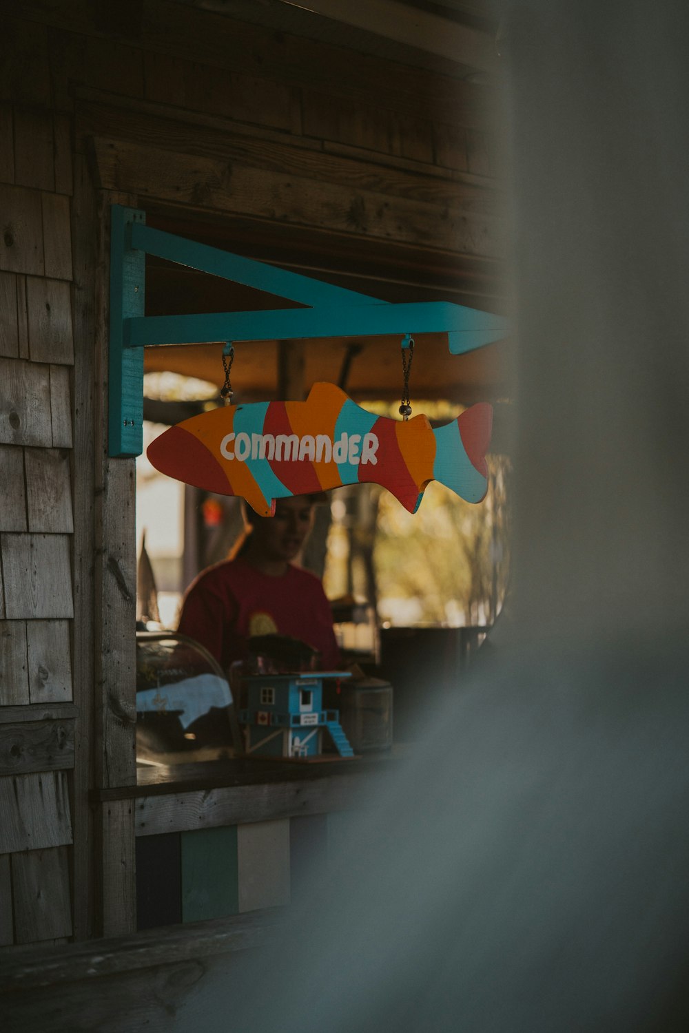 a man sitting at a table with a surfboard on top of it