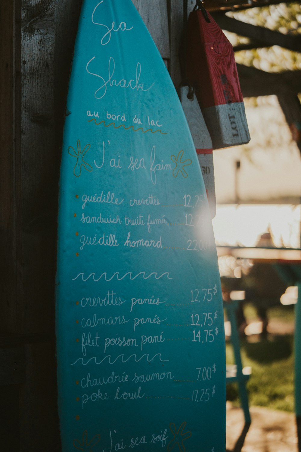 a blue surfboard with a menu written on it