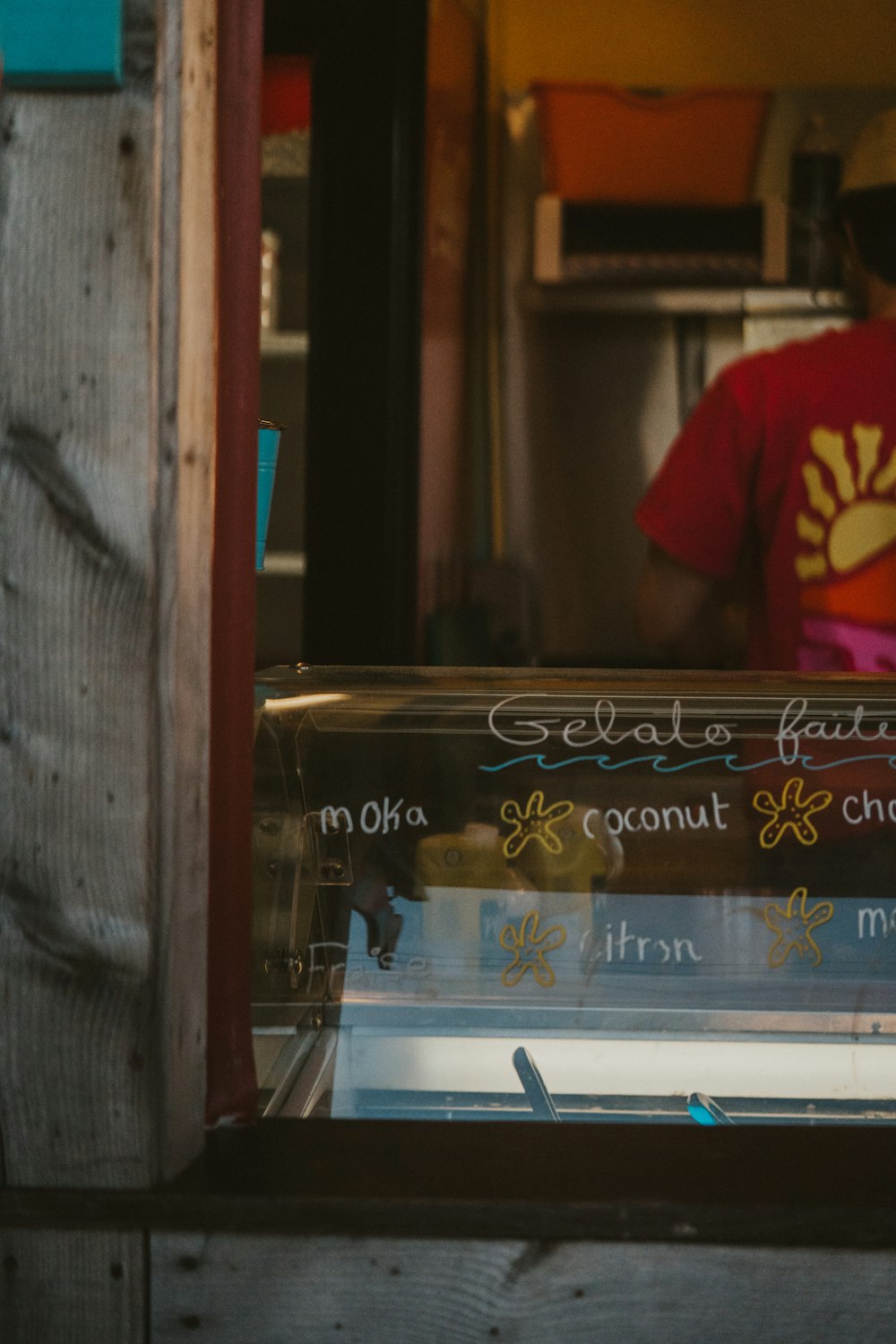 a man standing behind a counter in a restaurant