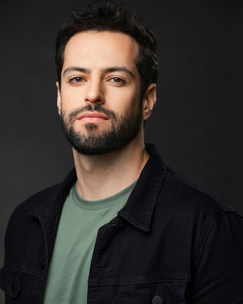 a man with a beard and a green shirt