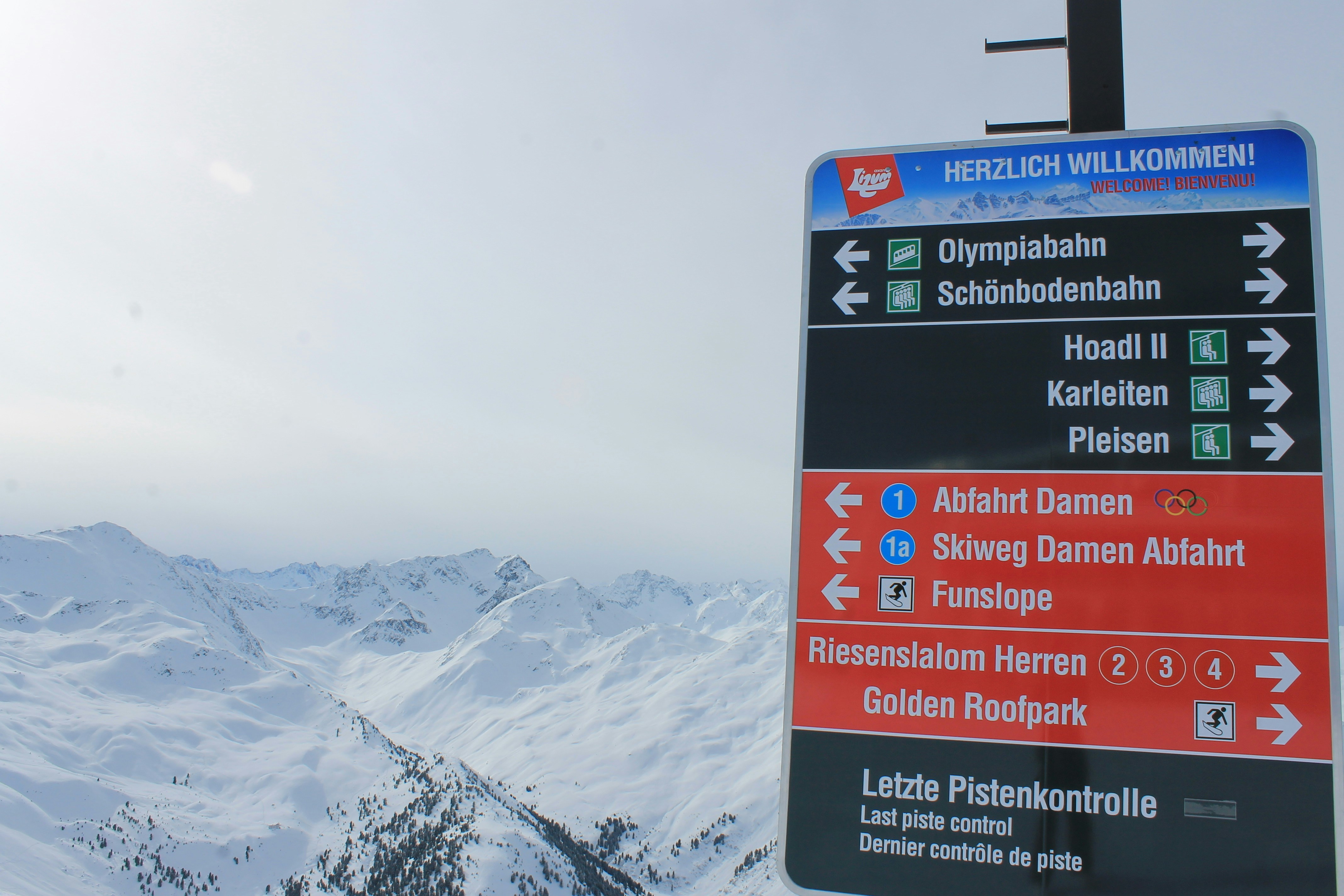 A sign pointing in different directions on a snowy mountain photo ...