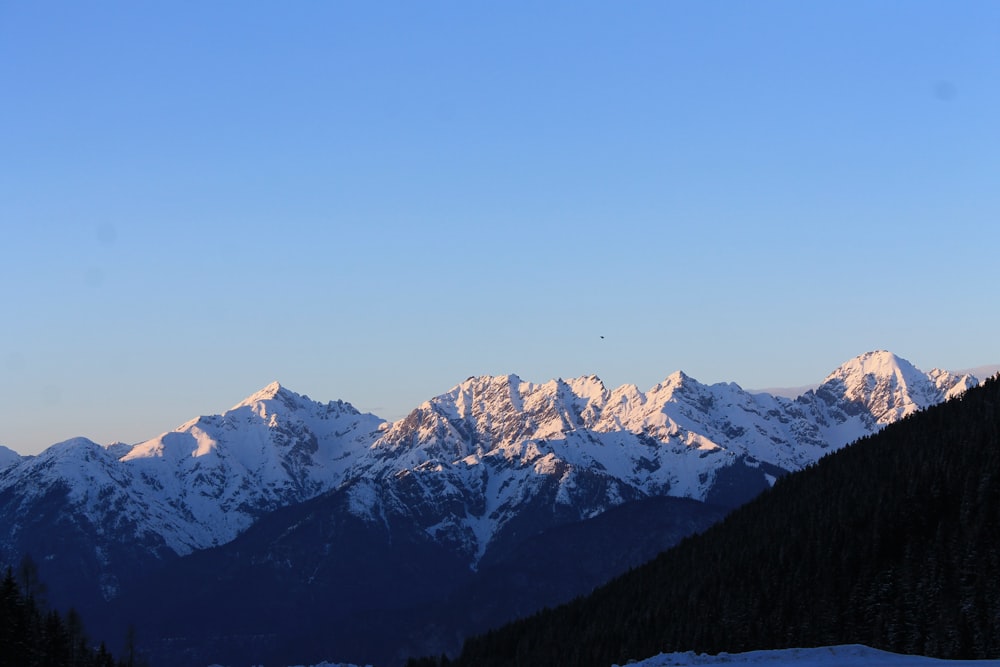 a view of a mountain range with snow on it