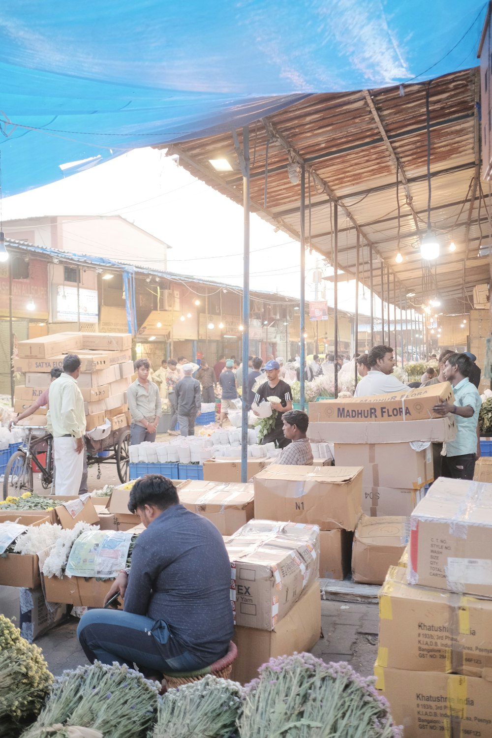 a man sitting on the ground surrounded by boxes