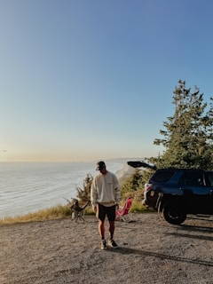 Sunset view of the Pacific Ocean coastline with a motorhome parked near the beach