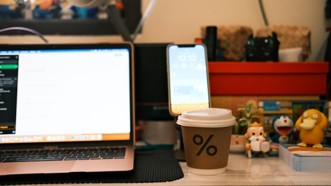 A cozy workspace with collectible action figures and a laptop ready for customer messages.