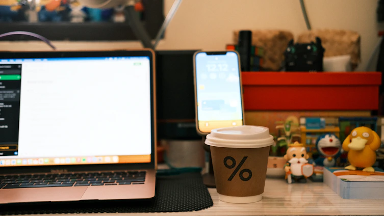 A cozy workspace with a smartphone displaying a colorful Android game, surrounded by creative sketches and tools.