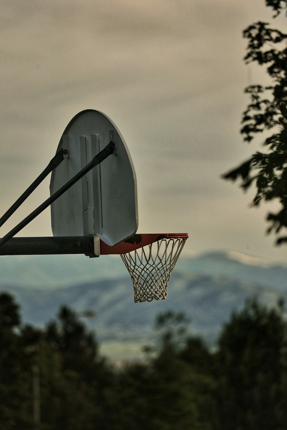 a basketball hoop with a view of mountains in the background