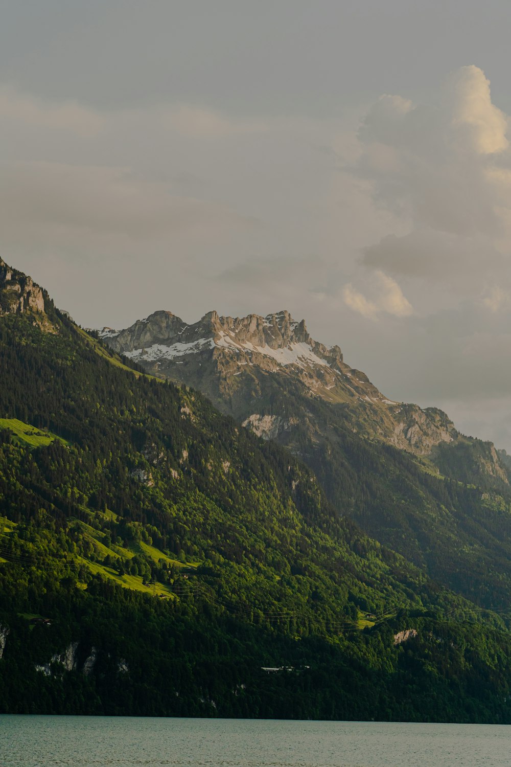 a large body of water with mountains in the background