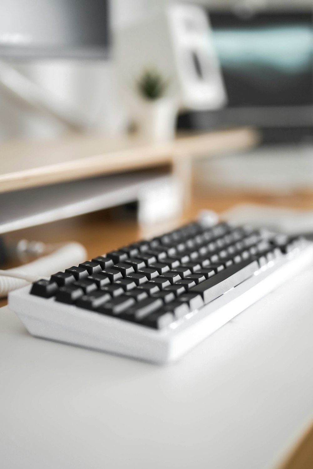 a computer keyboard sitting on top of a white desk