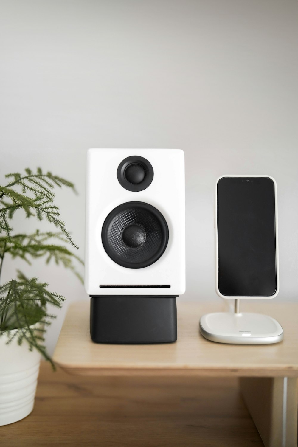 a pair of speakers sitting on top of a wooden table