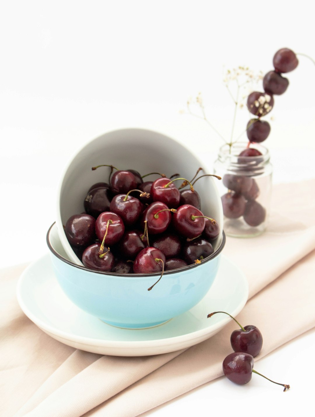 a bowl of cherries sitting on a table