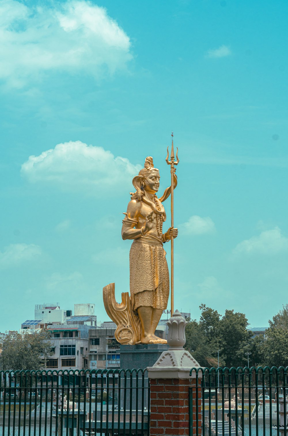 a golden statue of a woman holding a spear