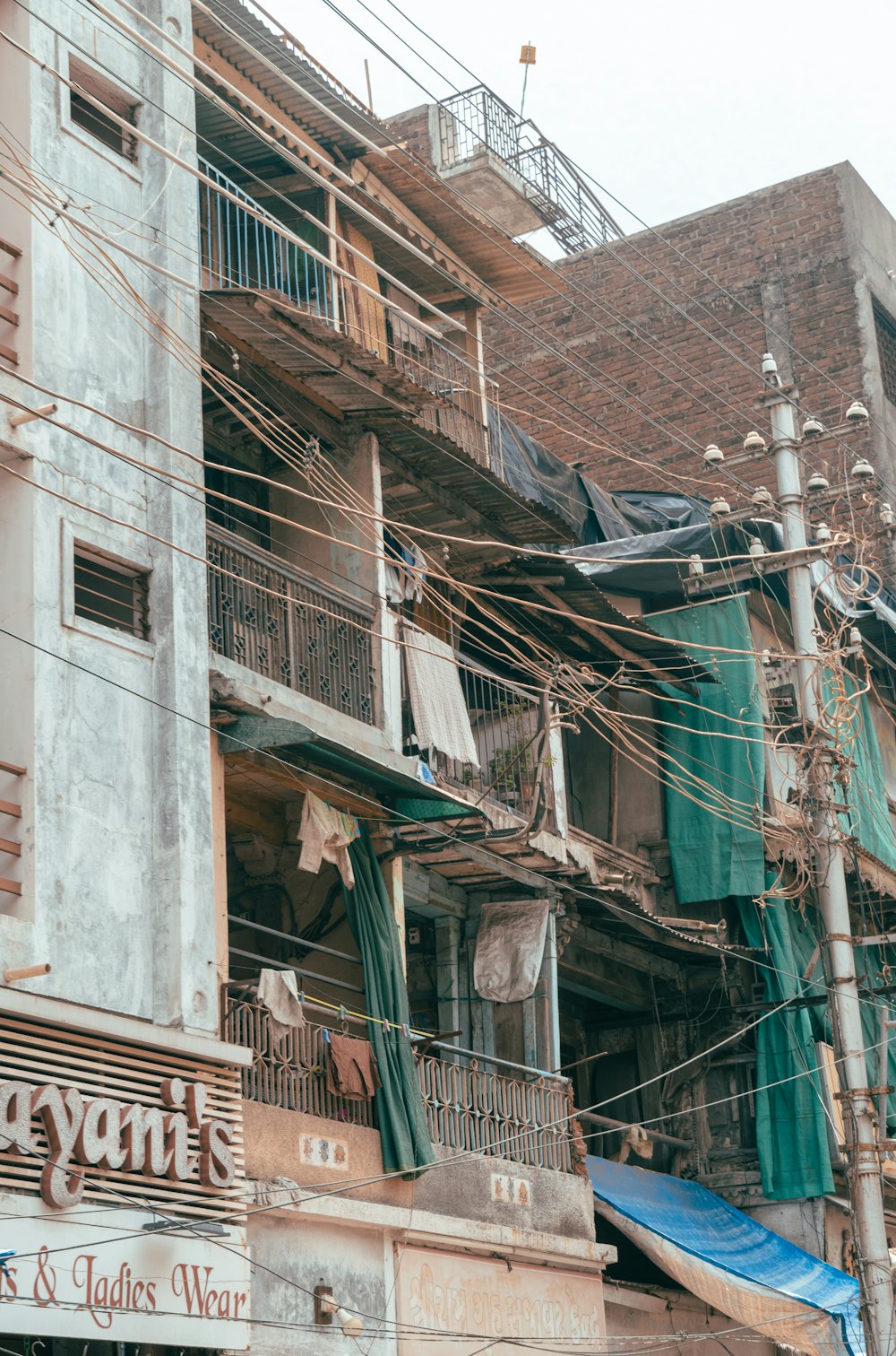 a building with a bunch of wires hanging from it's sides